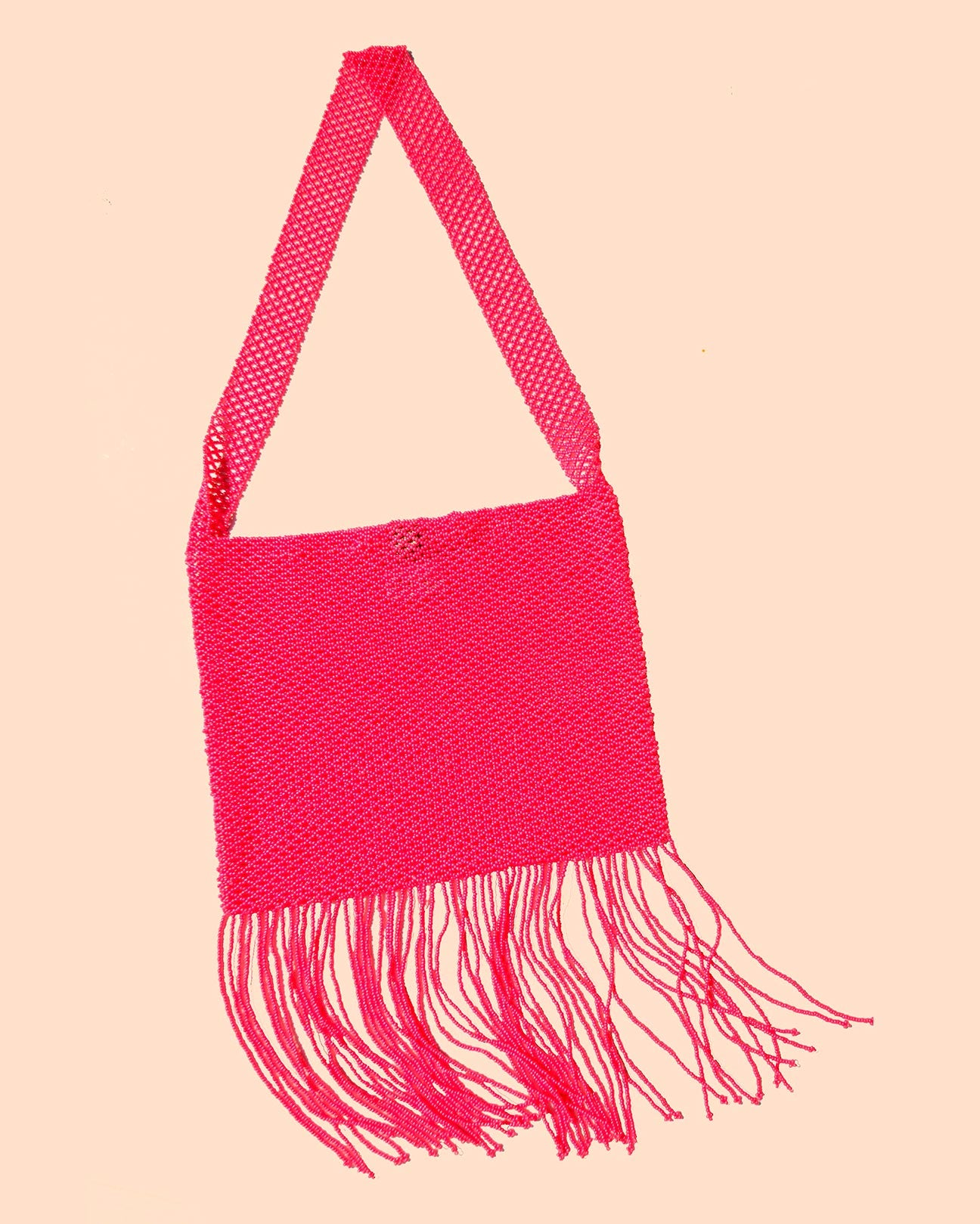 A product picture of the Marmaclub Crossover Fringe bag in color Hot Pink (medium dark pink))